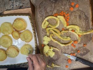 Hand scooping the center of roasted sweet potato rounds to create wells for Deviled No Eggs Potatoes.