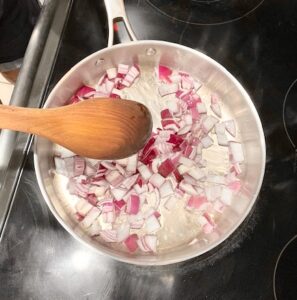 Best No-Tomato Sauce step with red onion sautéing in stainless steel pan with wooden spoon, nightshade free, dairy free, AIP compliant