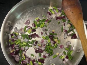 Rainbow Veggie Stew beginning with sautéed red onion and fleur d’ail in avocado oil for an anti-inflammatory AIP elimination phase recipe.