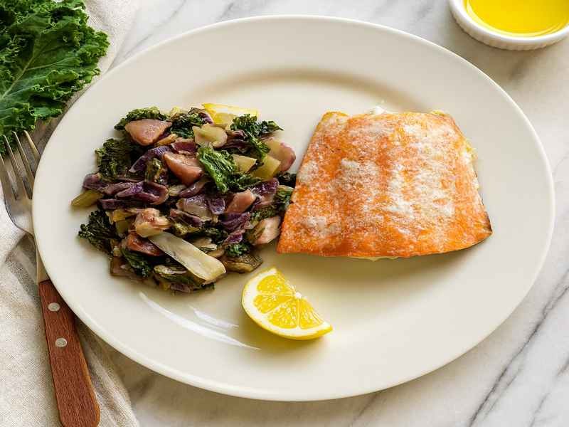 Rainbow Veggie Stew served with wild salmon lemon wedge and olive oil for a colorful AIP friendly gut healing autoimmune protocol meal.