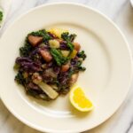 Rainbow Veggie Stew served on a cream plate with kale, cabbage, parsnips, and a lemon wedge. AIP, anti-inflammatory, and gut-healing vegetable dish.