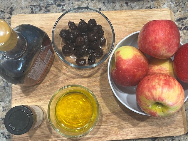 Ingredients for Baked Apples with Cherries including apples, sweet cherries, maple syrup, avocado oil, and cinnamon.