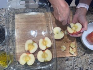 Scooping out the center of apples to prepare for Baked Apples with Cherries, dairy free healthy dessert.