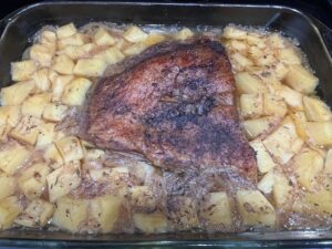 Best AIP Mouth-Melting Brisket baked with sweet potatoes and onions in a glass dish. Gluten free, dairy free, soy free, and nightshade free slow-baked AIP dinner full of herbs and apple cider vinegar.