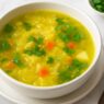 Cabbage and Potato Soup dairy free gluten free AIP-friendly comfort soup with fresh cilantro on marble table in natural sunlight