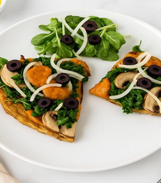 Tasty AIP Pizza Crust on marble table, topped with kale, mushrooms, and olives, served with a fresh salad — healthy, gluten-free, gut-friendly, and perfect for autoimmune diets.