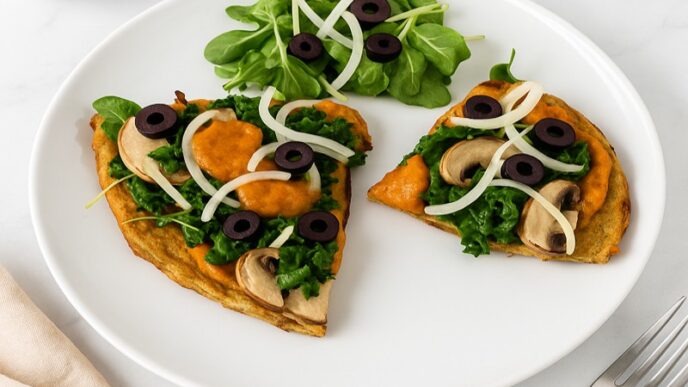 Tasty AIP Pizza Crust on marble table, topped with kale, mushrooms, and olives, served with a fresh salad — healthy, gluten-free, gut-friendly, and perfect for autoimmune diets.